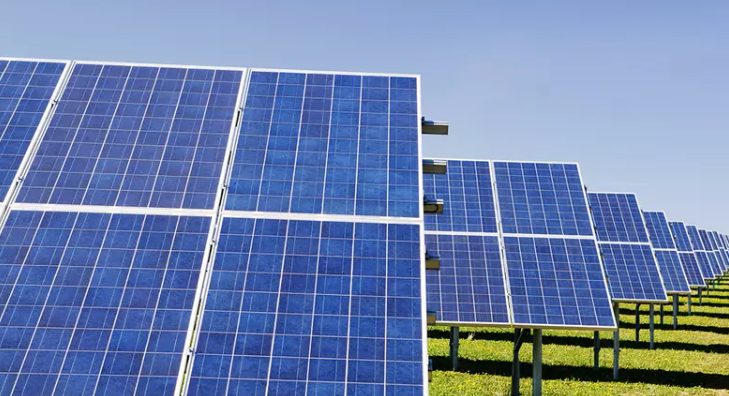 Image of solar panels installed on a rooftop under bright sunlight, generating clean renewable energy.